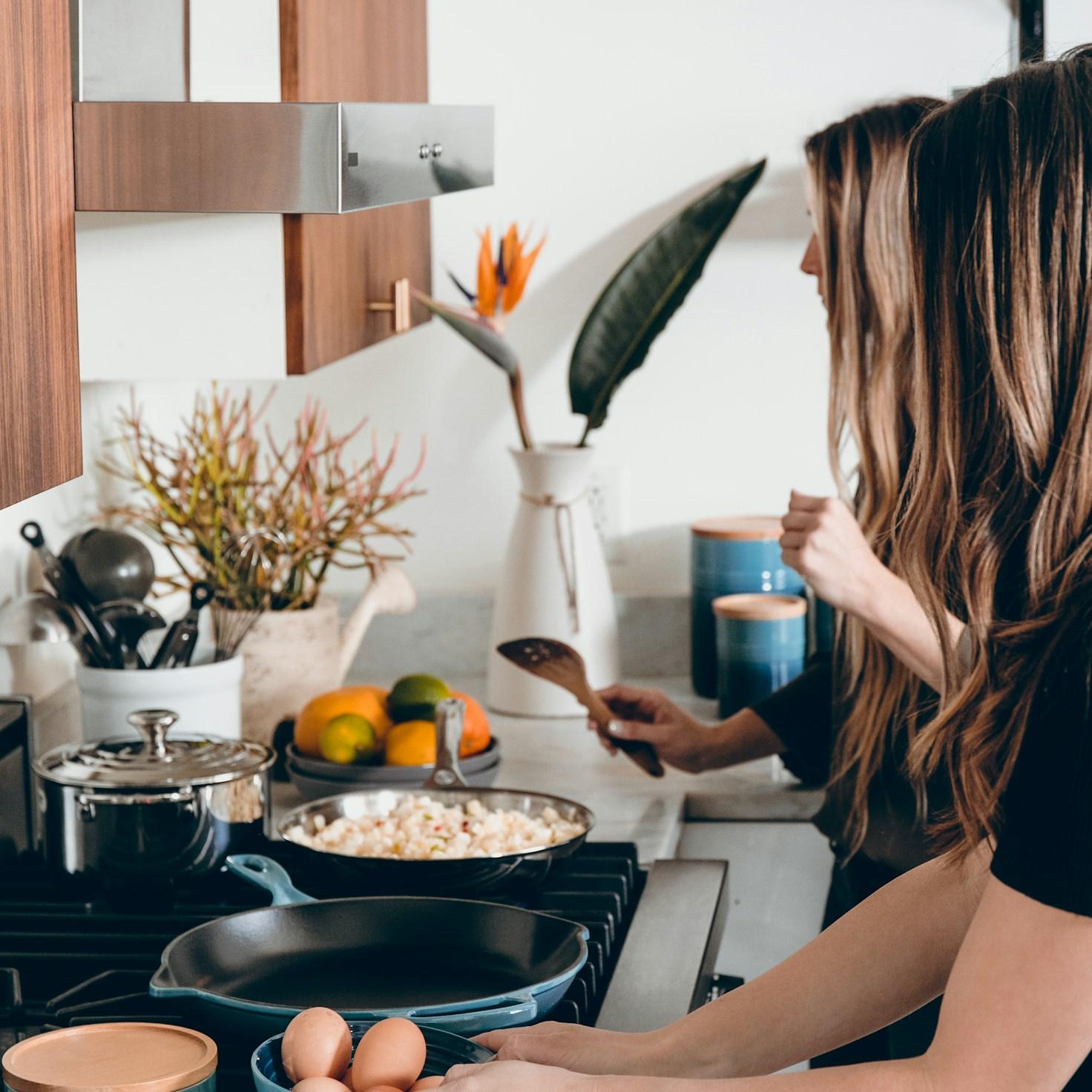 Community members collaborating in a modern kitchen space, exchanging recipes and techniques